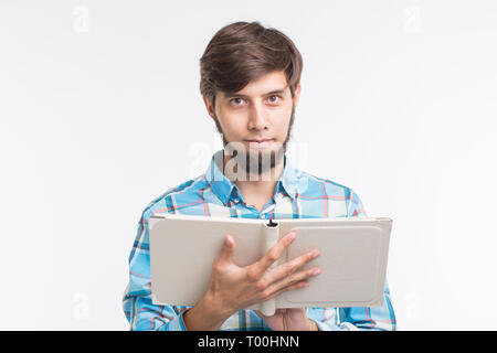 People, reading and education concept - young man reading a book on white background Stock Photo