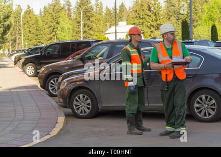 Moscow, Russia - May 12, 2018: Two public service employees discuss about work plan. Stock Photo