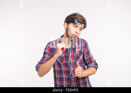 Expression and gesture concept - young bearded man in plaid shirt over white background Stock Photo