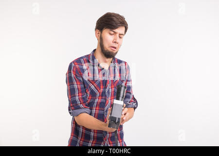 Emotions, photographer and people concept - man look at retro camera and confused because of it Stock Photo