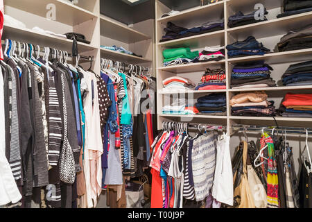 Interior Of Walk In Closet With Shelves And Clothes Rails