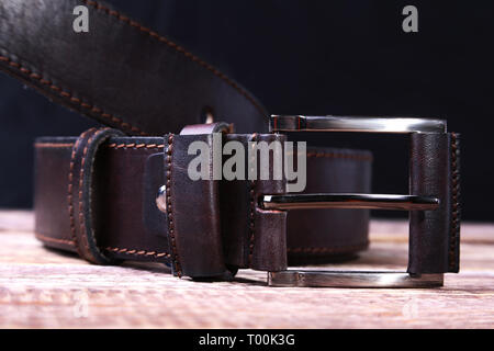 Men elegance leather belt on wooden table. Stock Photo