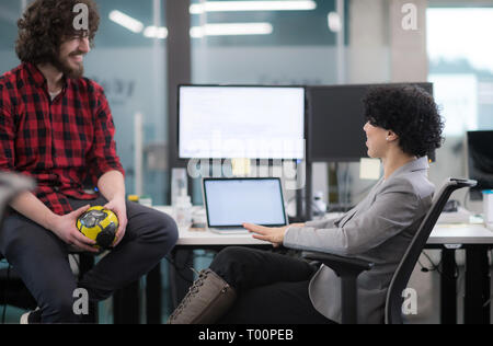 young software developers couple using laptop and desktop computer while writing programming code at modern creative startup office Stock Photo