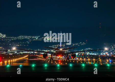 OSAKA, JAPAN - JAN. 4, 2019: ANA Boeing airplane taking off from the Itami International Airport in Osaka, Japan in the night. Stock Photo