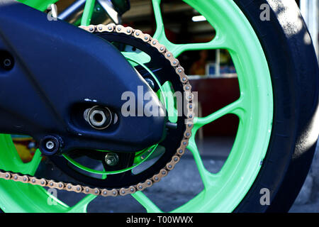 Photo of a gear plate and gear chain on the rear tire of a motorcycle Stock Photo