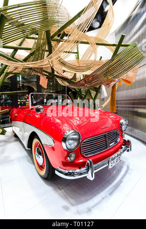 Nissan flagship showroom on the Ginza in Tokyo. Red Datsun Fair Lady car on display on rotating platform. Stock Photo
