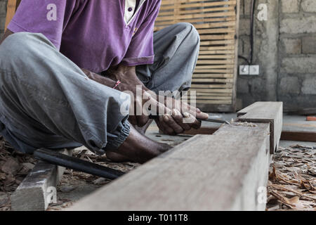 Close up of warn hands of carpenter working in traditional manual carpentry shop in a third world country. Stock Photo