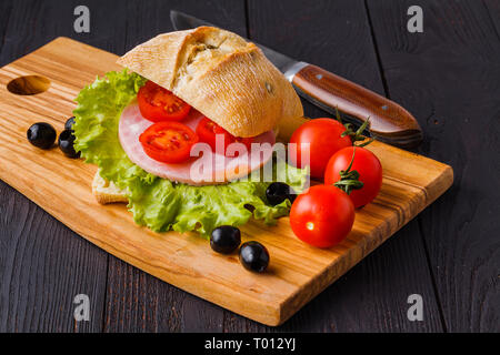 panini sandwiches with fresh tomatoes and mozzarella and prosciutto ham, Italian cuisine Stock Photo