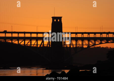 The end of the day as the sun sets over Anglesey behind the Britannia Bridge Stock Photo