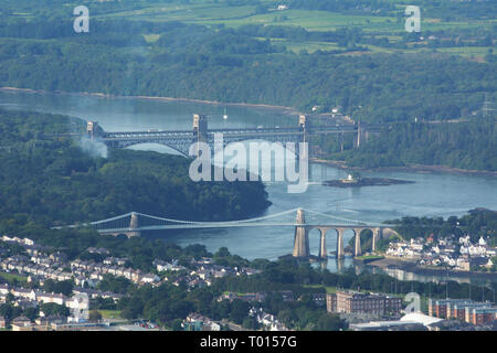 Looking down the Menai Strait at the Menai Suspension and the Britannia bridge from the air, showing the coast of Anglesey. Stock Photo