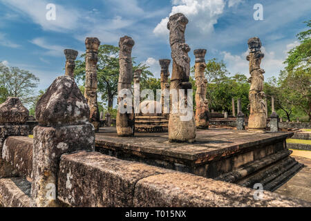 The remaining standing columns of a Buddhist monastery at the ancient city in Polonnarawu in the Central Province of Sri Lanka. Stock Photo