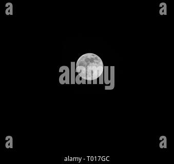 A full moon in the dark black sky at night Stock Photo - Alamy