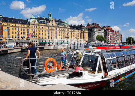 Stockholm, Sweden - July 12, 2018: One sightseeing boat has stoped at the Nybroviken stop and passengers disembarks. Stock Photo