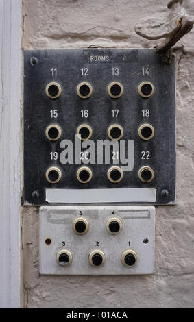 an old intercom or buzzer panel for multiple rooms, mounted on a brick wall Stock Photo