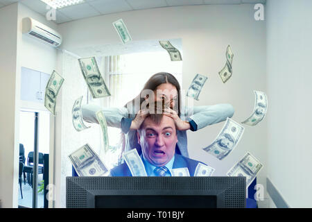 Crazy businessman, banknotes fly out of monitor Stock Photo