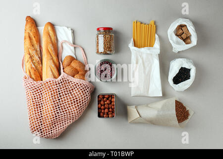 zero waste food shopping. eco natural bags and glass jar with food, eco friendly, flat lay. sustainable lifestyle concept. plastic free items. reuse,  Stock Photo