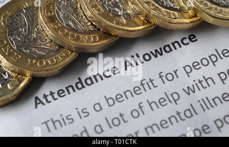 DWP  ATTENDANCE ALLOWANCE PAYMENT LEAFLET WITH ONE POUND COINS RE BENEFITS THE ELDERLY PENSIONERS LOW INCOME PENSION CREDIT ETC UK Stock Photo