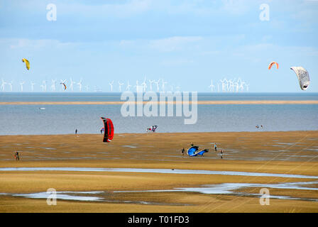 Kite flying on the beach, Hunstanton, Norfolk, England, with wind farm in the distance Stock Photo