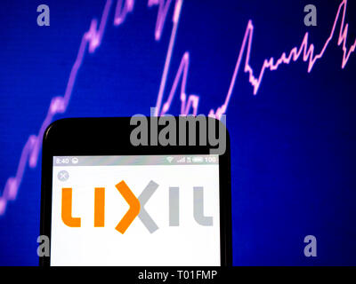 Lixil Group Corporation  logo seen displayed on smart phone. Stock Photo