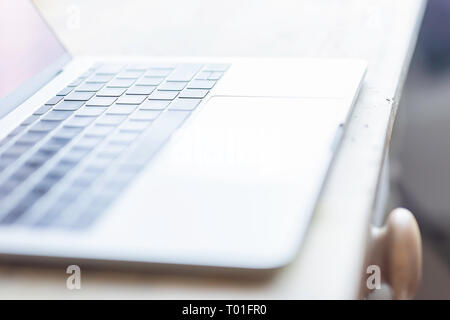 Blurred image of laptop computer placed on wooden table.Wireless connectivity.Online shopping.Home broadband.Wifi connection.5G.Technology.Business. Stock Photo