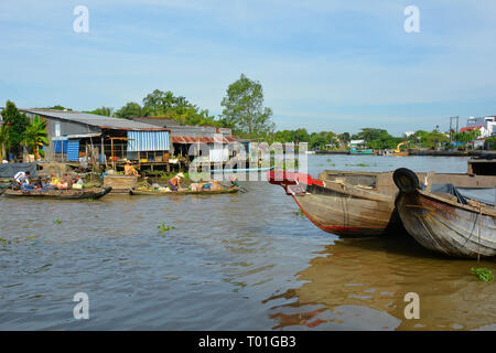 Phong Dien, Vietnam - December 31st 2017. The bows of two boats on the river at the Phong Dien Floating Market near Can Tho in the Mekong Delta Stock Photo