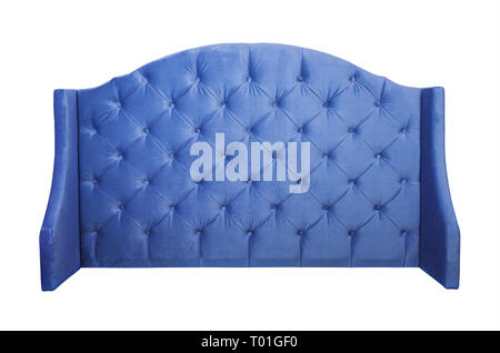 Shaped indigo blue color soft velvet fabric capitone bed headboard of Chesterfiels style sofa isolated on white background, front view Stock Photo