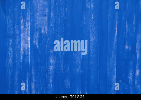 Abstract background texture of blue painted vivid metal wall surface with uneven grunge paint strokes, close up Stock Photo