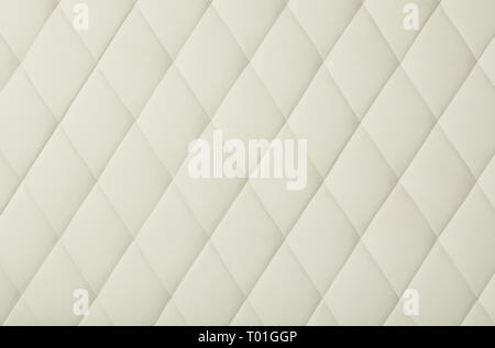 Background texture of white leather soft tufted furniture or wall panel upholstery with deep diamond pattern, close up Stock Photo