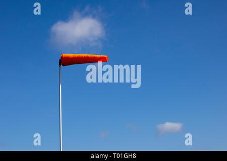 Airfield windsock, used to indicate wind speed and direction, shown ...
