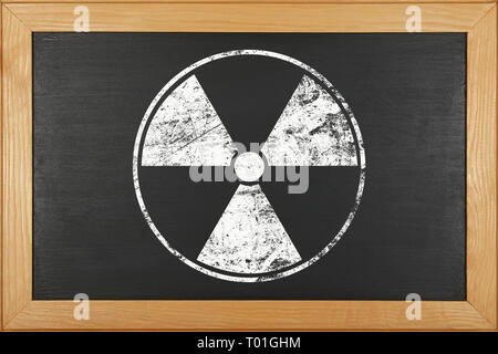 White chalk radioactive hazard warning sign over grunge black ...