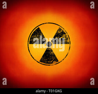 Black radioactive hazard warning sign painted over grunge yellow and red background with copy space Stock Photo