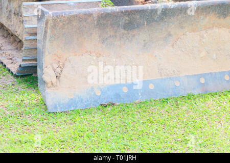 excavator bucket close up On the green grass Stock Photo