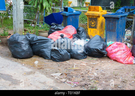 Pile black garbage roadside and Rain drops on the bag in the city with copy space add text Stock Photo