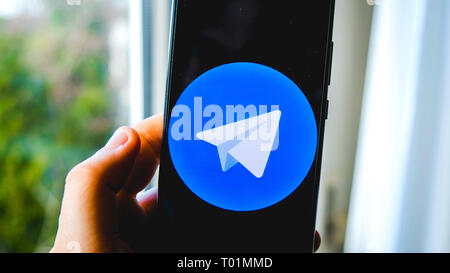 use Telegram app hand smartphone background Stock Photo