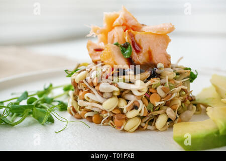 Salad of germinated seeds, trout and avocado. Macrobiotic food concept. Stock Photo