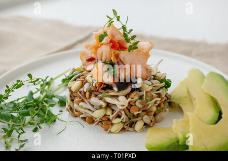 Salad of germinated seeds, trout and avocado. Macrobiotic food concept. Stock Photo