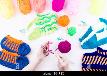 girl knits sock knitting needles on green background Stock Photo - Alamy
