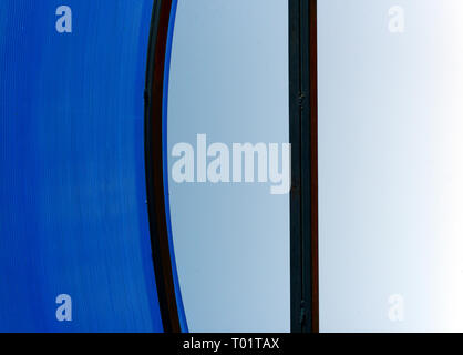 Single image of a clear blue acrylic bus top roof against a blue sky Stock Photo