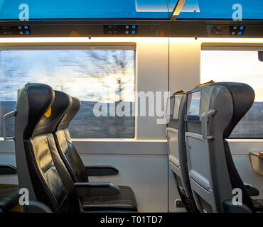 View of seats driving train with landscape outside the window. Screens and comfortable travel. Stock Photo