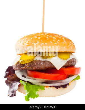 Appetizing cheeseburger with grilled beef patty, fresh vegetables and pickled cucumbers. Isolated over white background Stock Photo