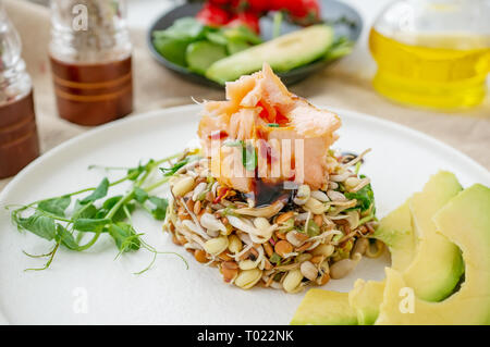 Salad of germinated seeds, trout and avocado. Macrobiotic food concept. Stock Photo