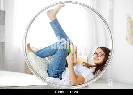 Beautiful child reading a book in the room. Concept of education, hobby, study and world book day Stock Photo