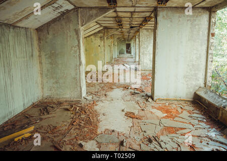 Old football stadium in Chornobyl exclusion zone. Radioactive zone in Pripyat city - abandoned ghost town. Chernobyl history of catastrophe Stock Photo