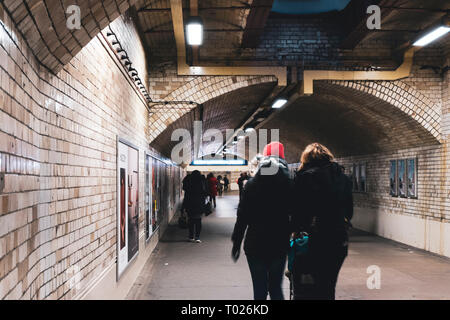 London, UK - March 19 2018: Busy people walking by in the South Kensington pedestrian tunnel in London linking from station to museums. Stock Photo