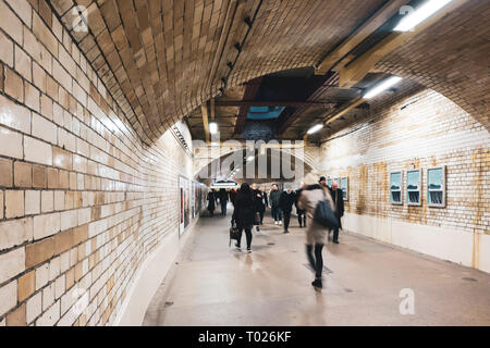 London, UK - March 19 2018: South Kensington pedestrian tunnel in London linking from station to museums. Busy people walking by. Stock Photo