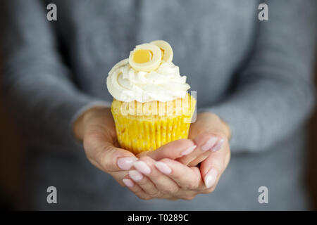 Delicious cupcake with cream and sweet egg. Copy space. Concept for food, desserts, bakery, celebration, birthday Stock Photo