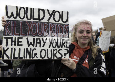 London, Greater London, UK. 15th Mar, 2019. A student seen holding a placard reading 'Would you kill your kids the way you're killing ours?'' during the protest.Hundreds of young people gathered at Parliament Square, joining the Global Climate Strike and demanding from the government and politicians direct actions to tackle the climate change. Students in more than 100 countries went to the streets to participate in a climate global strike. Credit: Andres Pantoja/SOPA Images/ZUMA Wire/Alamy Live News Stock Photo