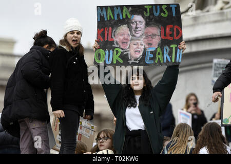 London, Greater London, UK. 15th Mar, 2019. A student seen holding a placard reading 'Mama just killed our earth'' during the protest.Hundreds of young people gathered at Parliament Square, joining the Global Climate Strike and demanding from the government and politicians direct actions to tackle the climate change. Students in more than 100 countries went to the streets to participate in a climate global strike. Credit: Andres Pantoja/SOPA Images/ZUMA Wire/Alamy Live News Stock Photo