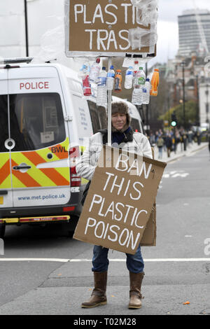 London, Greater London, UK. 15th Mar, 2019. Protester seen holding placards reading ''Plastic trash'' ''Ban this plastic poison'' during the protest.Hundreds of young people gathered at Parliament Square, joining the Global Climate Strike and demanding from the government and politicians direct actions to tackle the climate change. Students in more than 100 countries went to the streets to participate in a climate global strike. Credit: Andres Pantoja/SOPA Images/ZUMA Wire/Alamy Live News Stock Photo