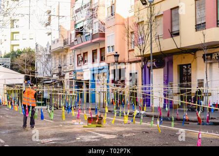 Valencia, Spain. 16th March 2019. Pyrotechnic technician preparing the trigger system of a mascleta with hundreds of firecrackers hanging in a Falla. Credit: Joaquin Corbalan pastor/Alamy Live News Stock Photo